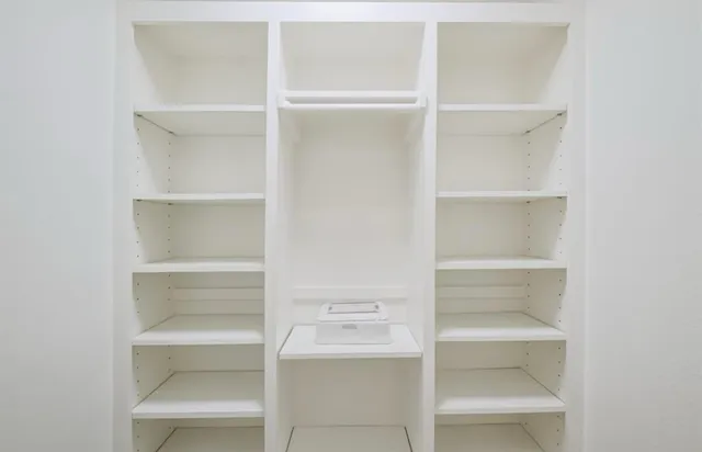 a bathroom with a sink toilet vanity and shower