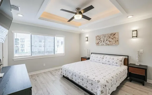 a bedroom with a bed and a flat screen tv