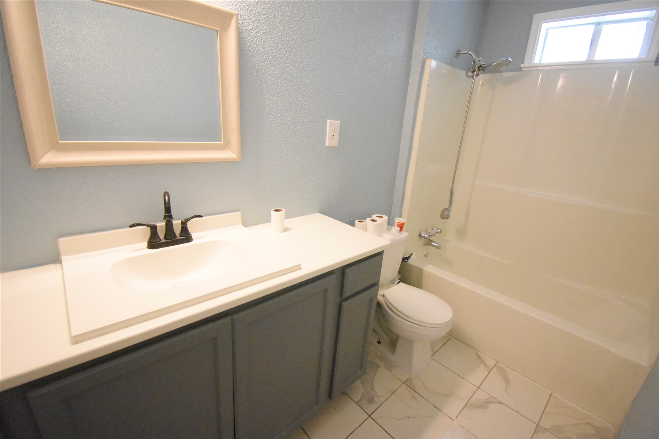 6229 Clover Ridge Street Houston, TX 77087 - Photo 19 of 25 a bathroom with a sink a toilet a mirror and shower