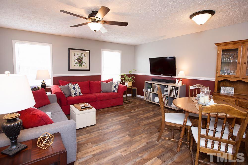 2225 Springhill Avenue Raleigh, NC 27603 - Photo 2 of 18 a living room with furniture and a flat screen tv