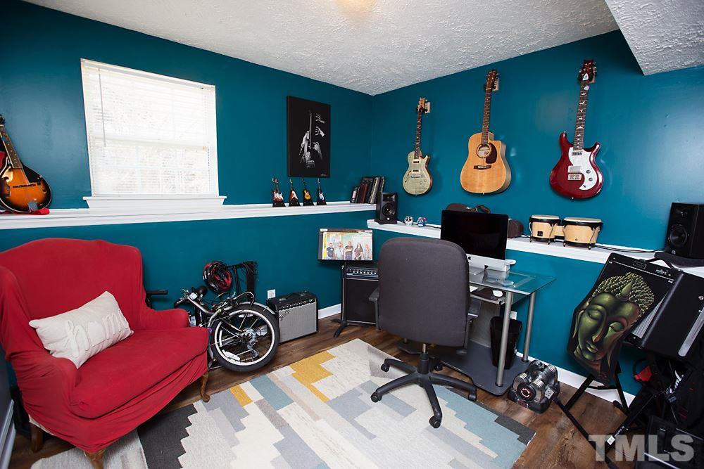 2225 Springhill Avenue Raleigh, NC 27603 - Photo 11 of 18 a view of a workspace with furniture and a window