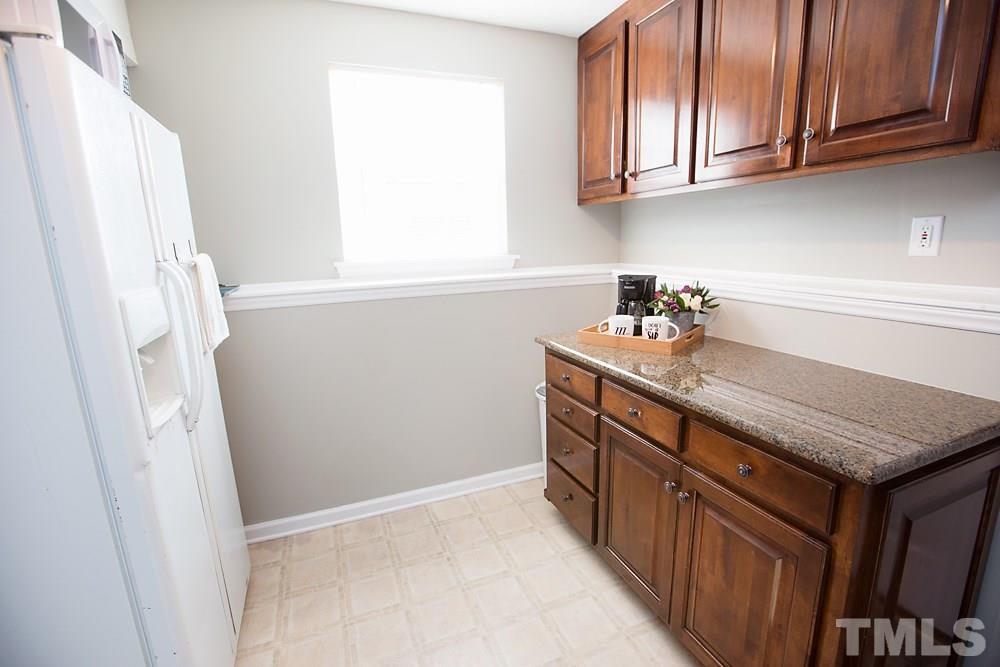 2225 Springhill Avenue Raleigh, NC 27603 - Photo 15 of 18 a kitchen with stainless steel appliances granite countertop a sink stove and cabinets
