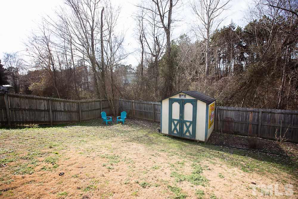 2225 Springhill Avenue Raleigh, NC 27603 - Photo 17 of 18 a house with trees in front of it