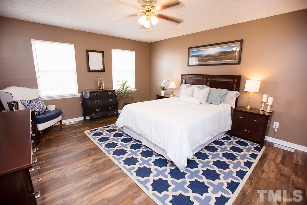 2225 Springhill Avenue Raleigh, NC 27603 - Photo 6 of 18 a bedroom with a bed and wooden floor