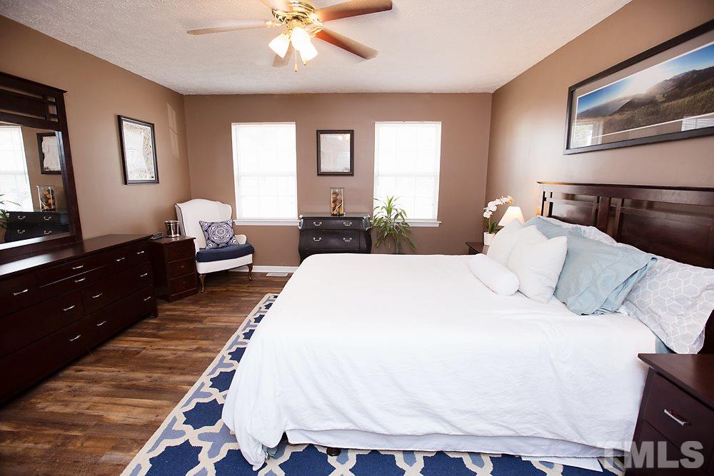 2225 Springhill Avenue Raleigh, NC 27603 - Photo 7 of 18 a spacious bedroom with a bed and window