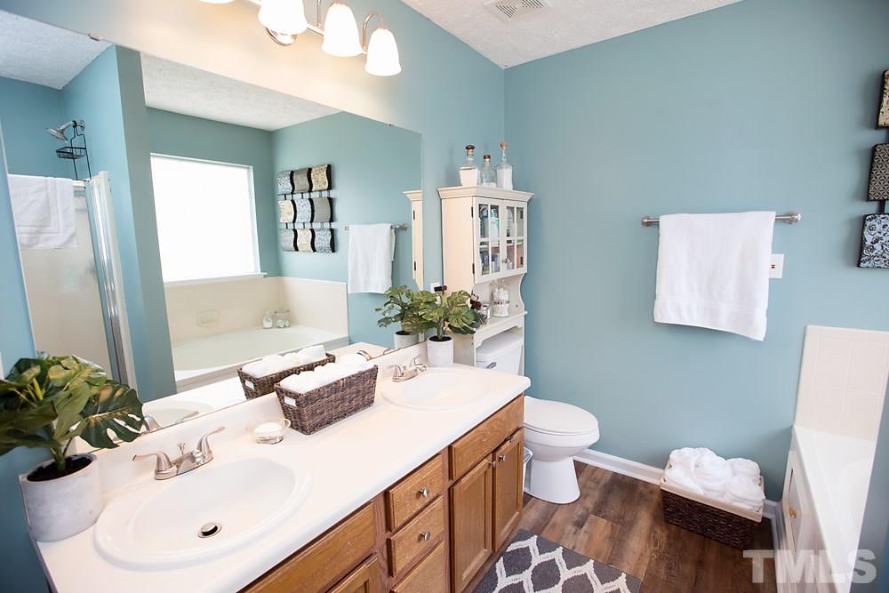 2225 Springhill Avenue Raleigh, NC 27603 - Photo 8 of 18 a bathroom with a sink toilet and mirror