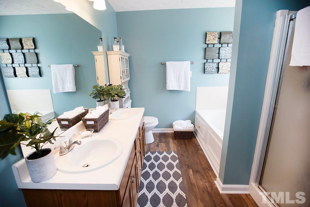 2225 Springhill Avenue Raleigh, NC 27603 - Photo 9 of 18 a bathroom with a sink and mirror with toilet
