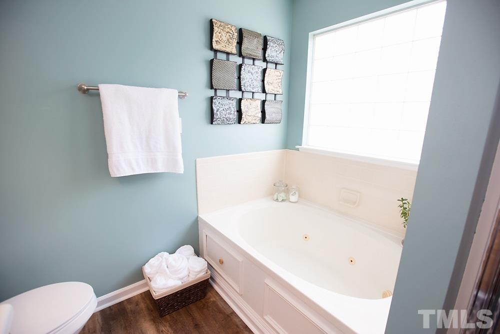 2225 Springhill Avenue Raleigh, NC 27603 - Photo 10 of 18 a bathroom with a sink and a toilet