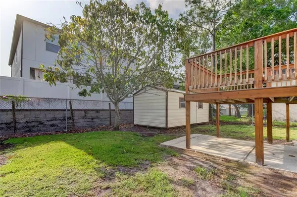 a view of a chair and table in the backyard