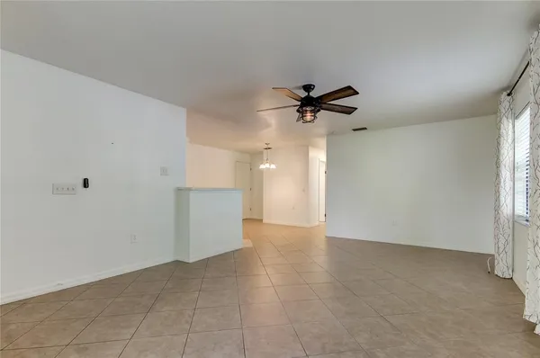 a view of a livingroom with a ceiling fan and window