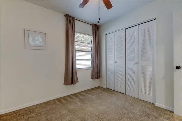 an empty room with windows and closet