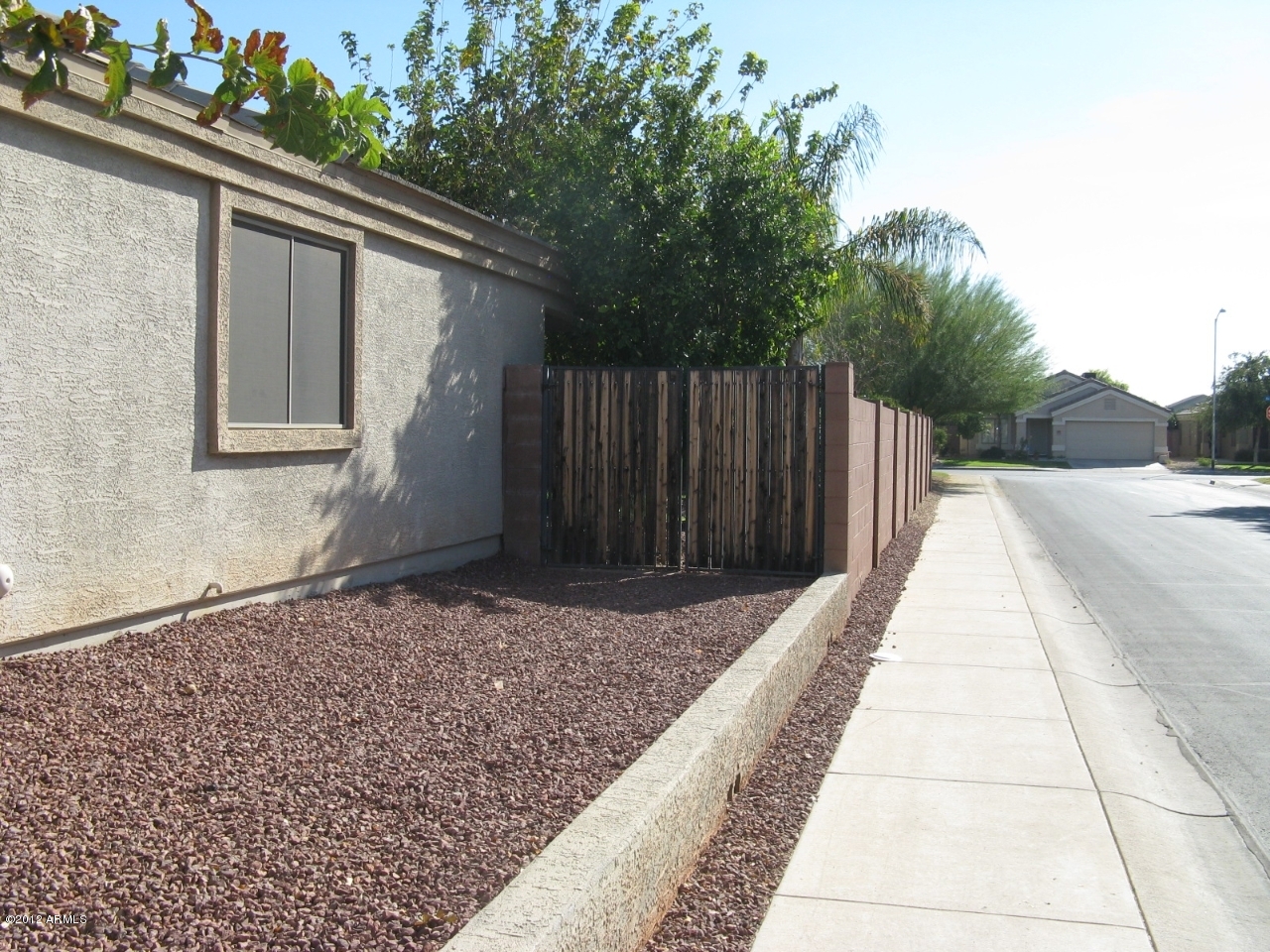 12537 West Redfield Road El Mirage, AZ 85335 - Photo 5 of 22 West side of the home with RV gates