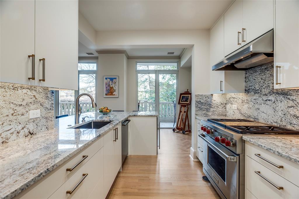 3505 Turtle Creek Boulevard, Unit 2F Dallas, TX 75219 - Photo 1 of 14 Gourmet kitchen with breakfast bar and tree-top view.