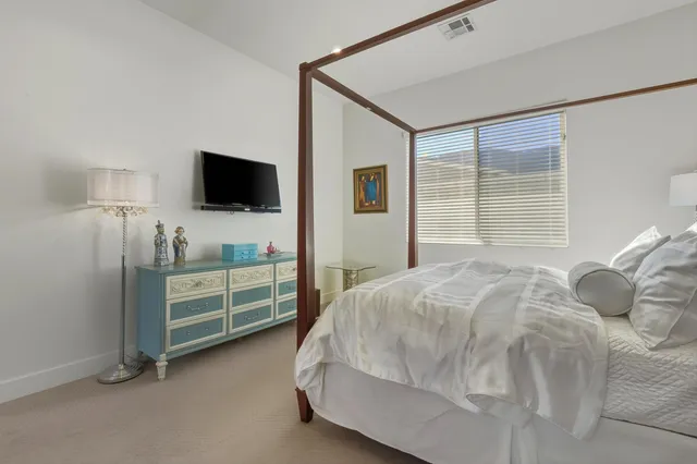 a living room with furniture a rug and a flat screen tv