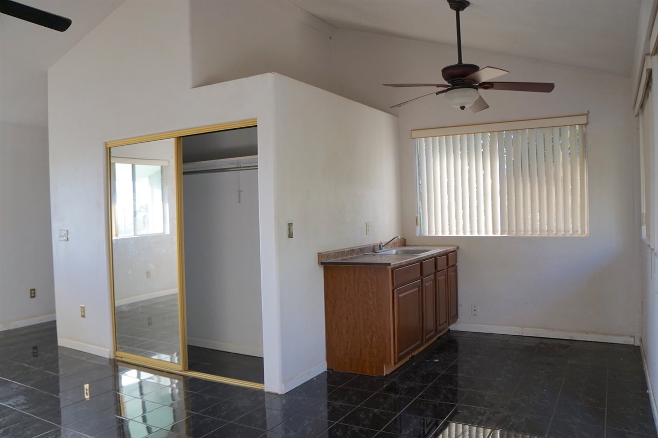 440 Mikioi Place Kihei, HI 96753 - Photo 15 of 28 a room with wooden floor and window