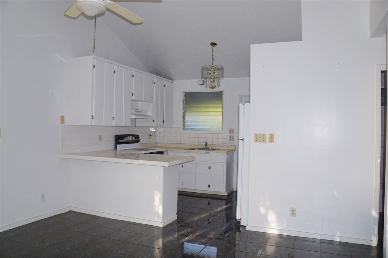 440 Mikioi Place Kihei, HI 96753 - Photo 19 of 28 a view of cabinets a sink and a stove