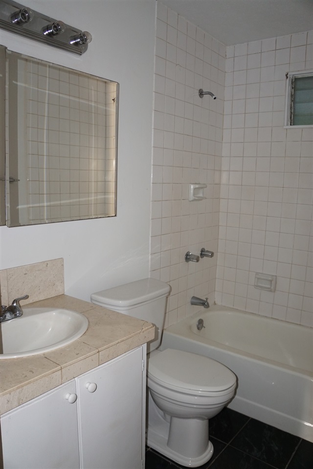 440 Mikioi Place Kihei, HI 96753 - Photo 22 of 28 a bathroom with a sink a toilet and shower