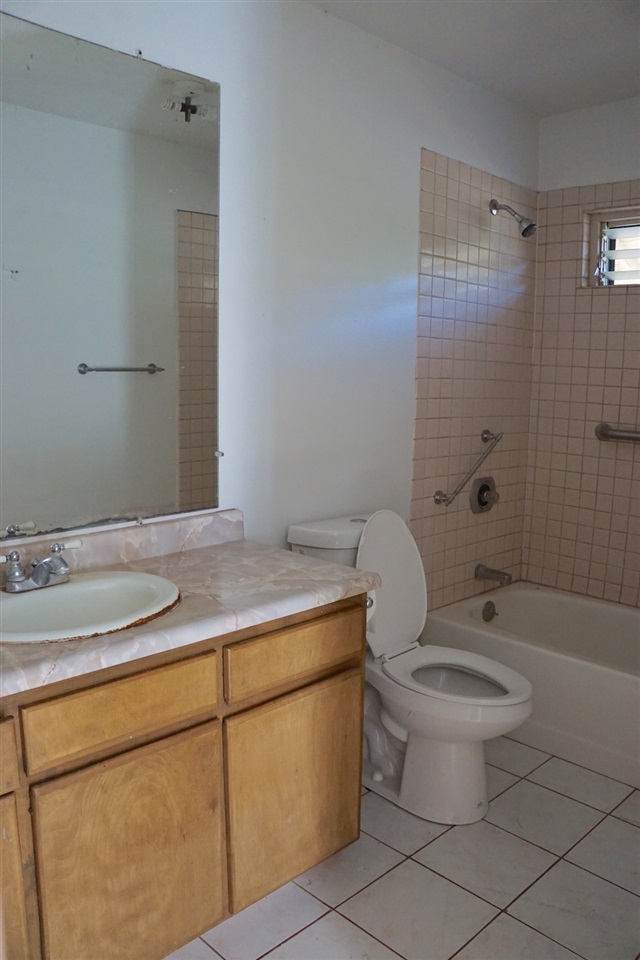 440 Mikioi Place Kihei, HI 96753 - Photo 10 of 28 a bathroom with a granite countertop sink toilet and shower