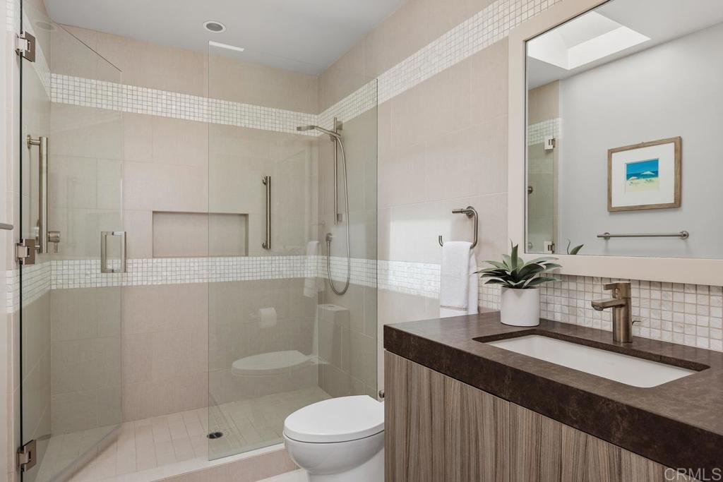 1856 Parliament Road Encinitas, CA 92024 - Photo 29 of 42 a bathroom with a sink a toilet and shower