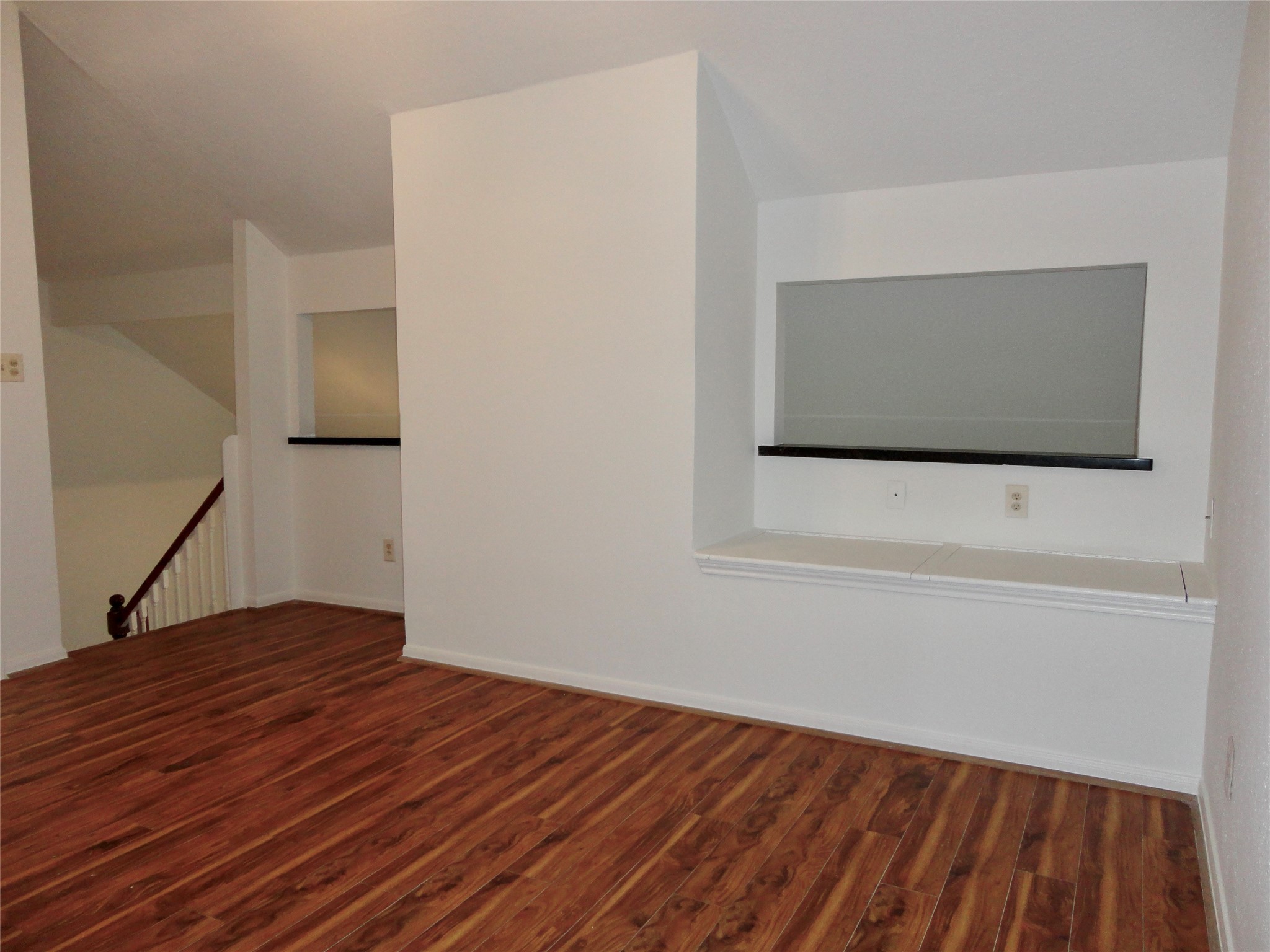 6700 Richardson Road, Unit 204 Houston, TX 77069 - Photo 16 of 39 a view of an empty room with wooden floor and cabinet