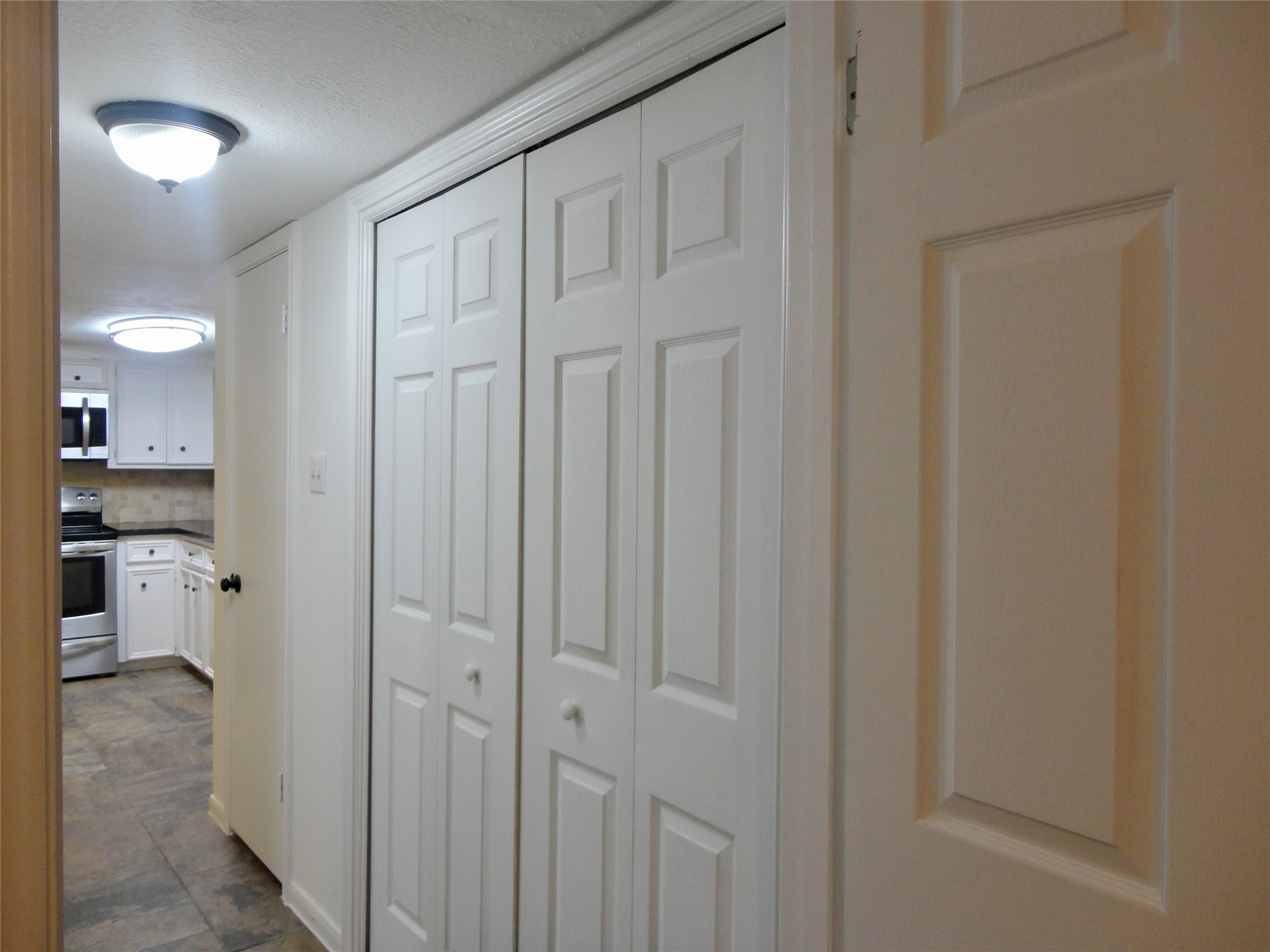 6700 Richardson Road, Unit 204 Houston, TX 77069 - Photo 29 of 39 a view of a hallway with a livingroom and a bathroom with toilet