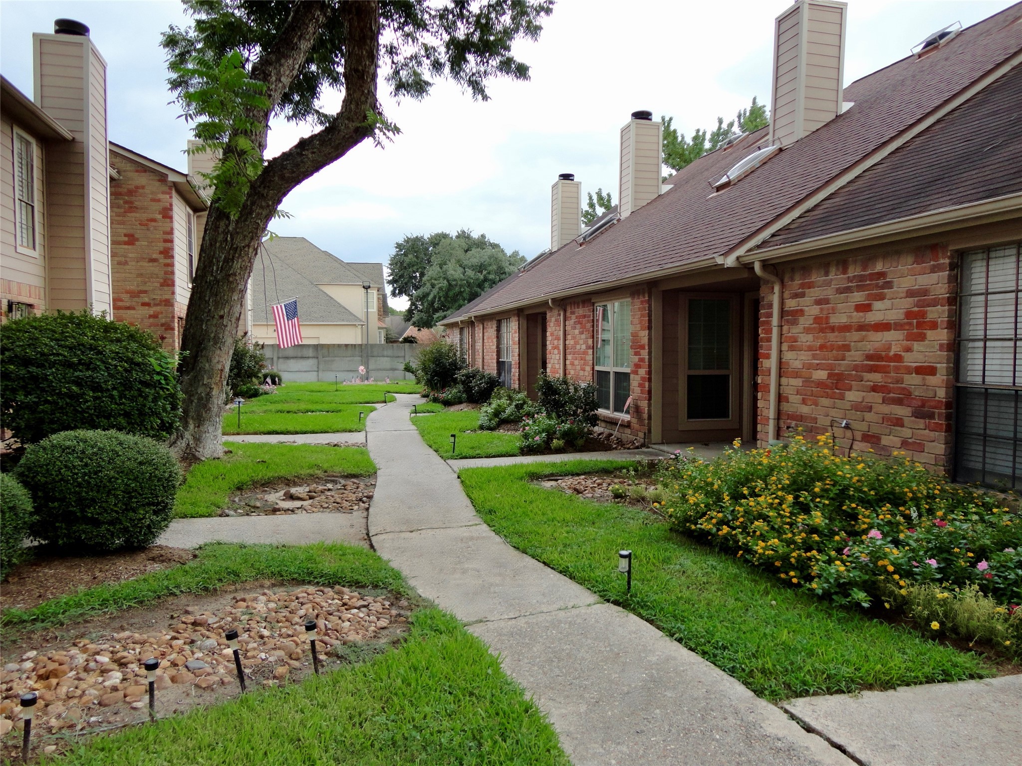 6700 Richardson Road, Unit 204 Houston, TX 77069 - Photo 37 of 39 a front view of a house with a yard