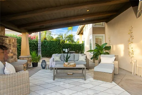 a living room with patio furniture and a fireplace