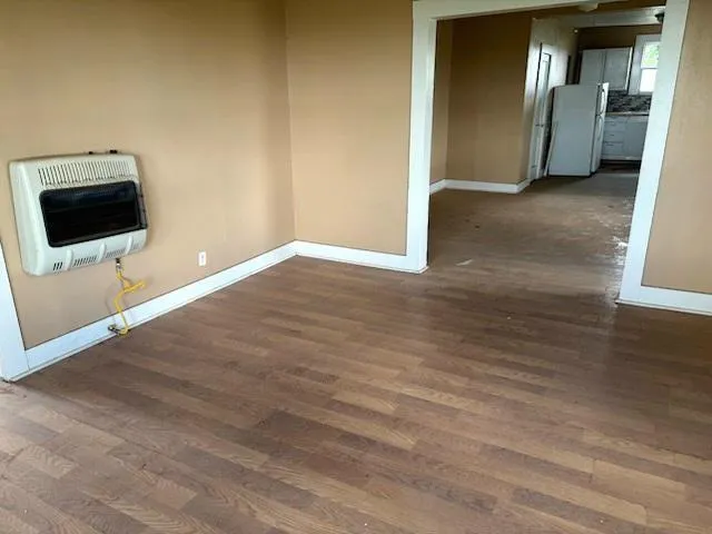 a view of a livingroom with wooden floor and a flat screen tv