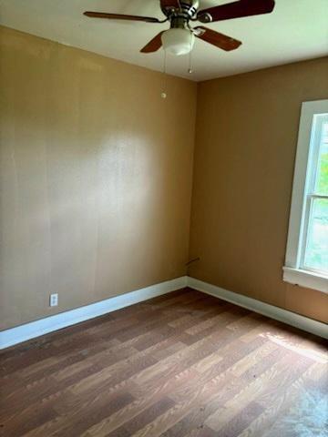 617 West Price Street Floydada, TX 79235 - Photo 9 of 12 an empty room with a window and a fan