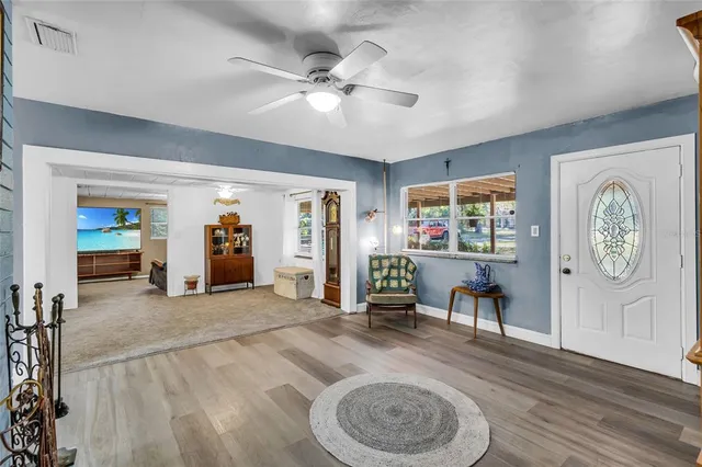 a view of a livingroom with furniture wooden floor and window
