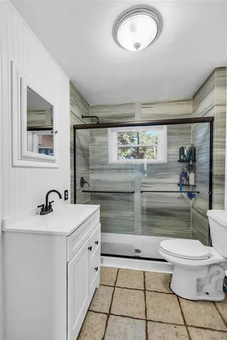 a bathroom with a sink a toilet and a mirror