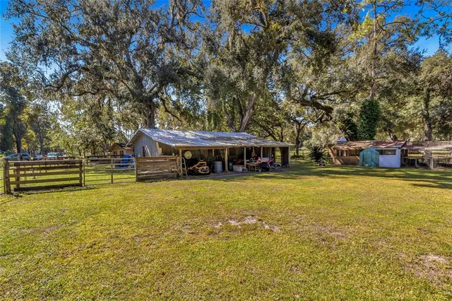 a view of a backyard with a table and chairs