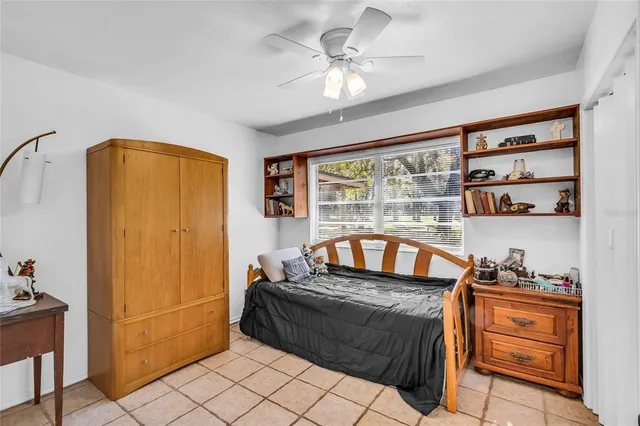 a living room with stainless steel appliances granite countertop furniture and a large window