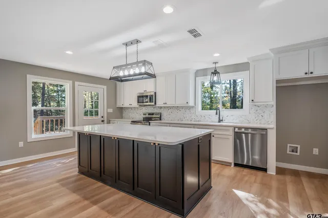 a kitchen with a sink stove and cabinets