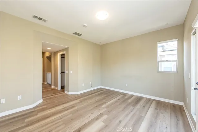 a view of wooden floor and windows in a room