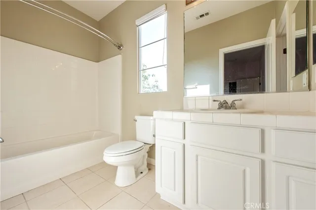 a bathroom with a sink toilet vanity and tub