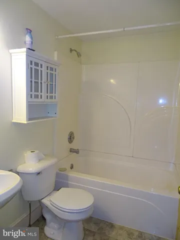 a bathroom with a toilet a sink and bathtub