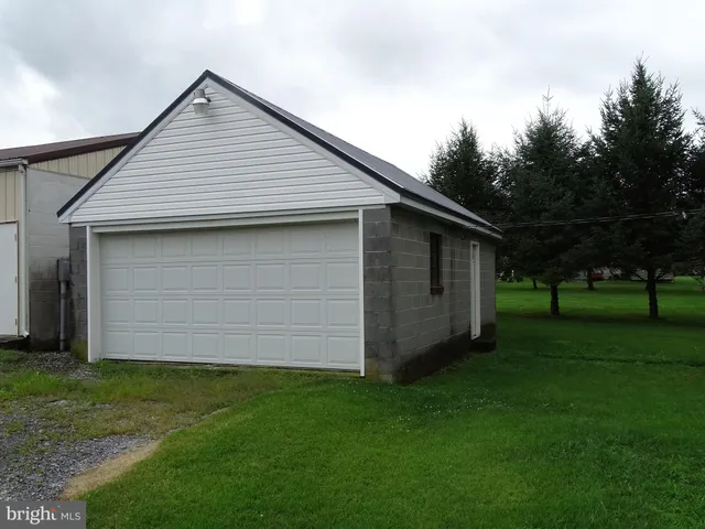 a front view of house with a garden