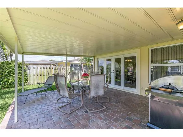 a view of a patio with table and chairs