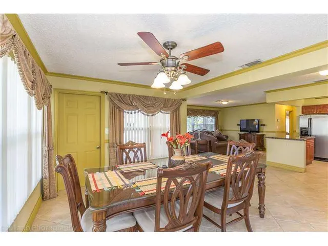 a view of a dining room with furniture and a chandelier