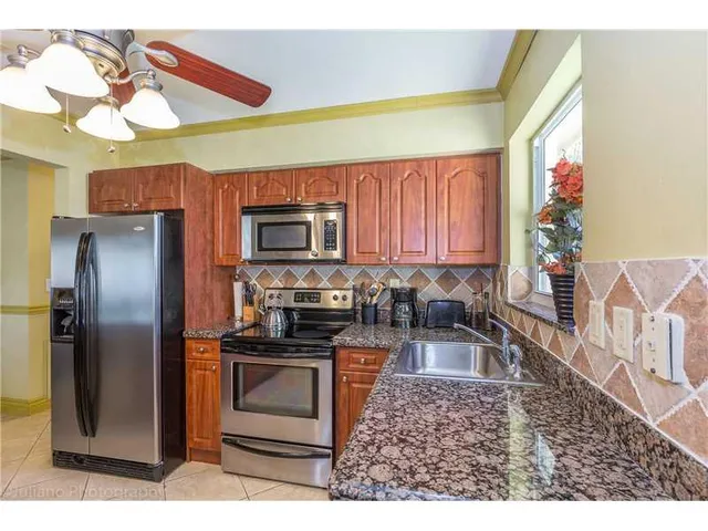 a kitchen with a refrigerator and a sink