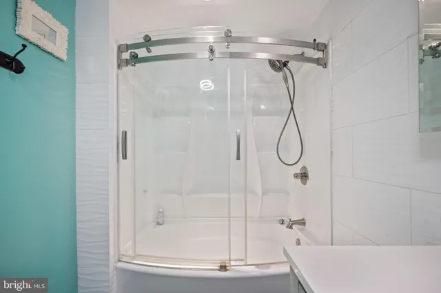 a bathroom with a glass shower door