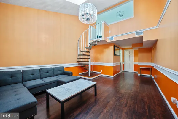 a view of livingroom with furniture wooden floor and front door