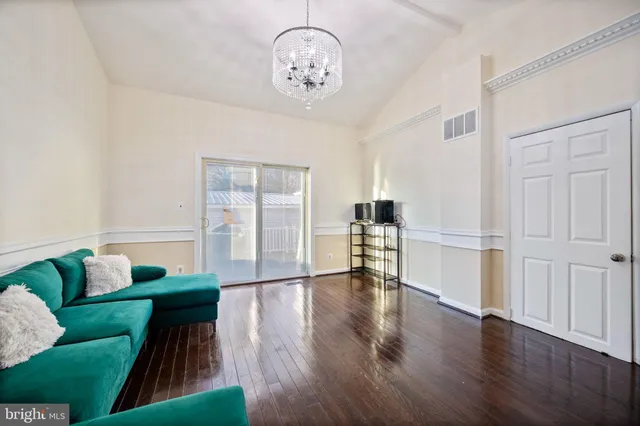 a view of a house with backyard and wooden fence