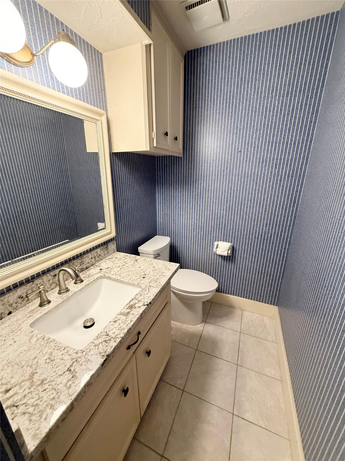 16711 Sir William Drive Spring, TX 77379 - Photo 18 of 21 a bathroom with a granite countertop sink a toilet and mirror