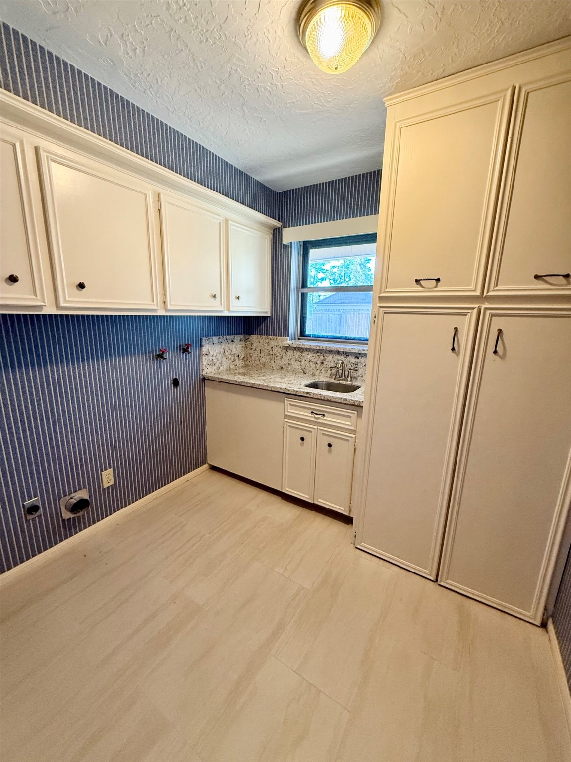 16711 Sir William Drive Spring, TX 77379 - Photo 19 of 21 a kitchen with white cabinets and white appliances