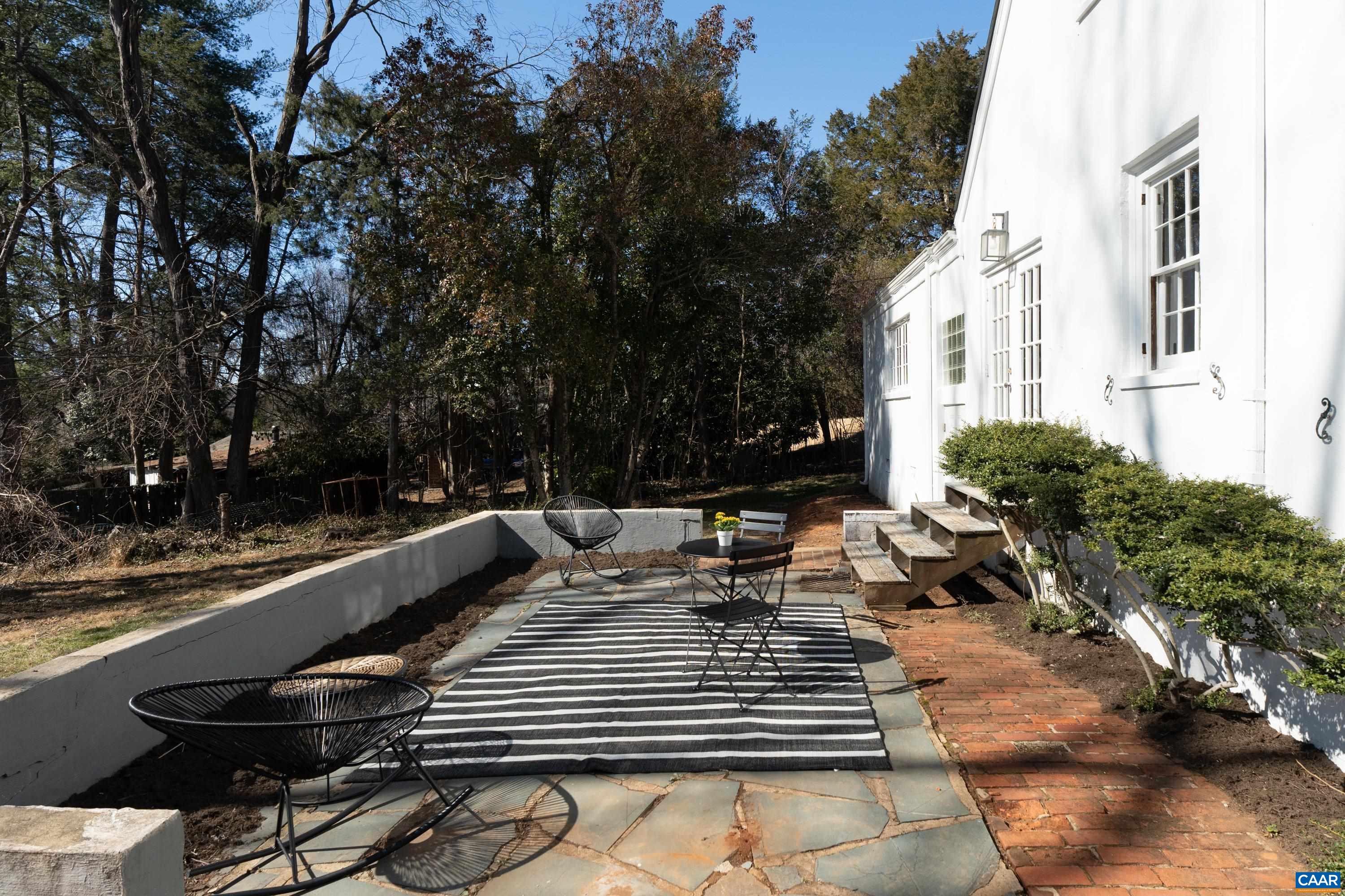 12 Old Farm Road Charlottesville, VA 22903 - Photo 39 of 39 a view of a patio with couches table and chairs with potted plants and large trees