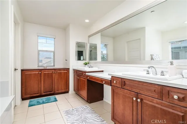 a spacious bathroom with a granite countertop sink and mirror