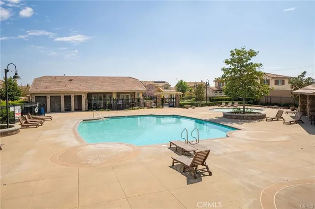 a view of swimming pool with outdoor seating and a garden