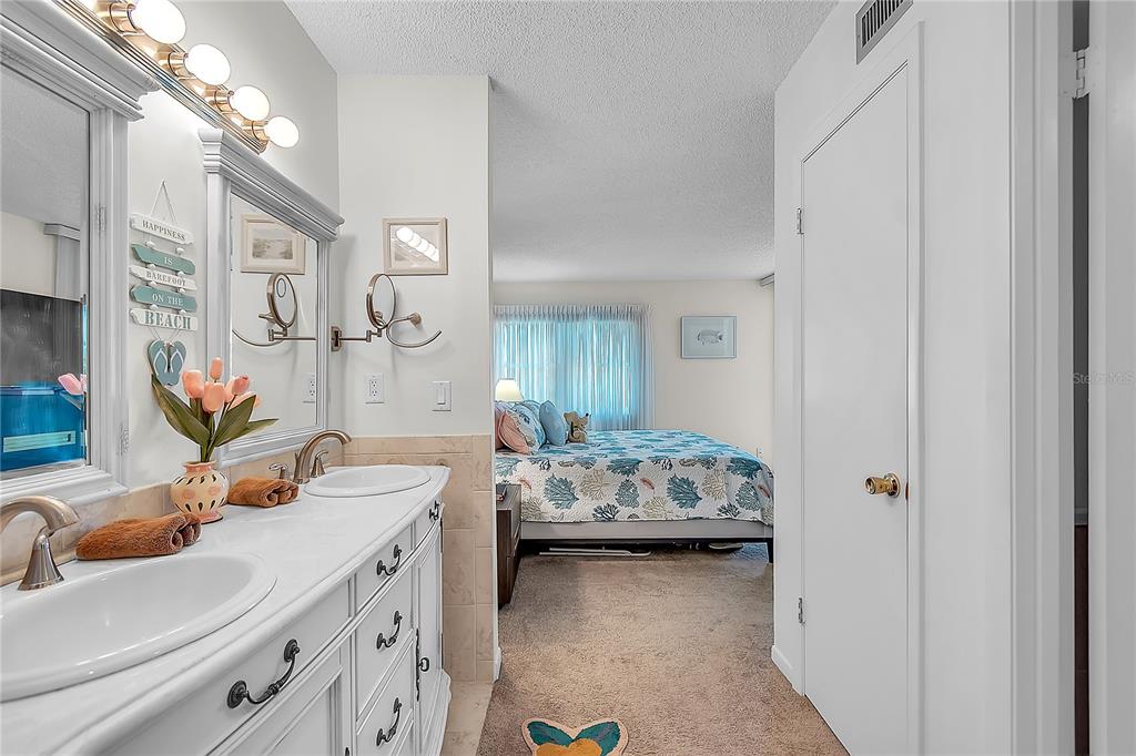 12200 Vonn Road, Unit 2206 Largo, FL 33774 - Photo 34 of 60 a bedroom with a bed and ceiling fan